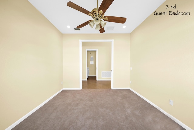 empty room with dark carpet and ceiling fan