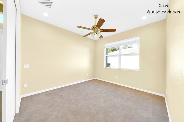 unfurnished room featuring light carpet and ceiling fan