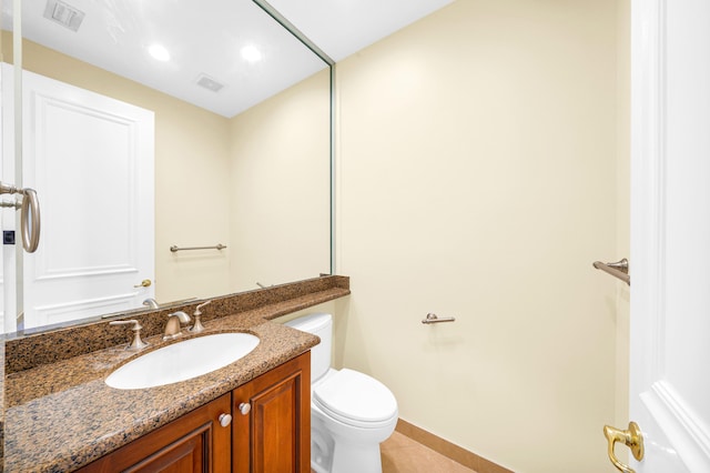 bathroom with toilet, tile floors, and oversized vanity