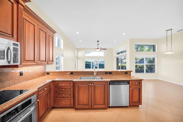 kitchen with appliances with stainless steel finishes, plenty of natural light, ceiling fan, and sink