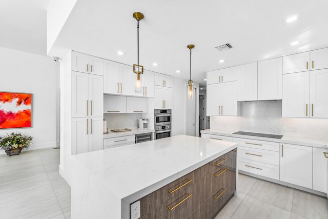 kitchen featuring white cabinetry, double oven, and a kitchen island