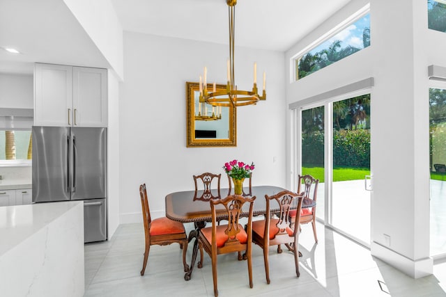 tiled dining room with a high ceiling and a notable chandelier