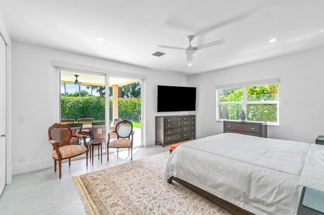 bedroom with ceiling fan and light tile floors