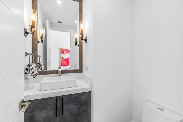 bathroom with toilet and vanity