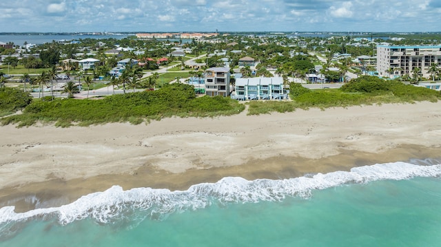 drone / aerial view featuring a water view and a view of the beach