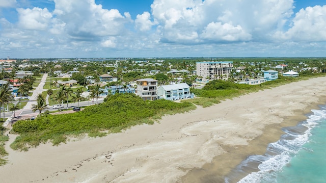 birds eye view of property featuring a beach view and a water view