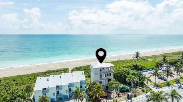 birds eye view of property with a view of the beach and a water view