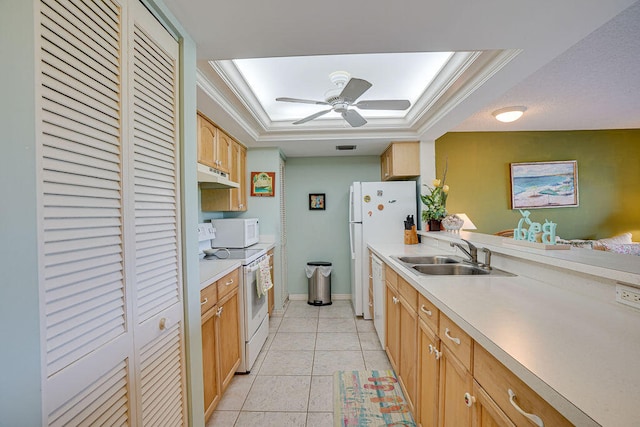 kitchen with white appliances, ceiling fan, a raised ceiling, and sink