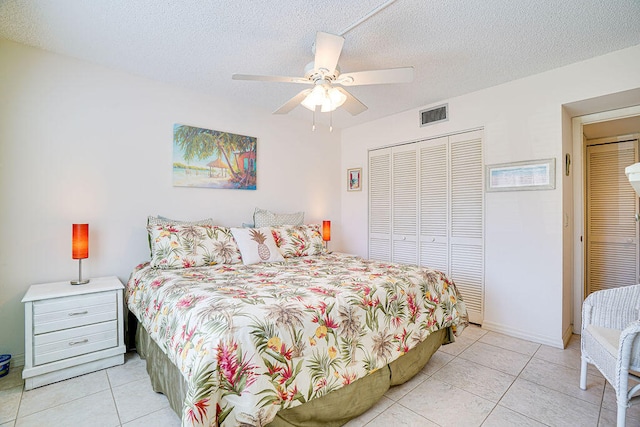 tiled bedroom featuring a textured ceiling, a closet, and ceiling fan