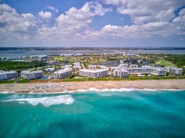 birds eye view of property with a beach view and a water view