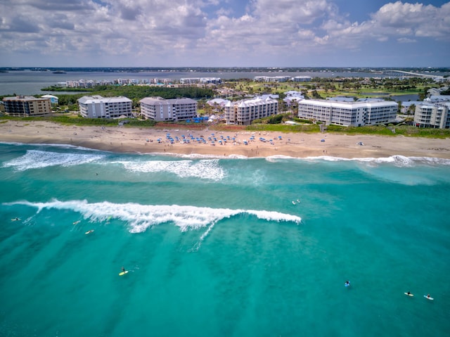 aerial view with a water view and a beach view