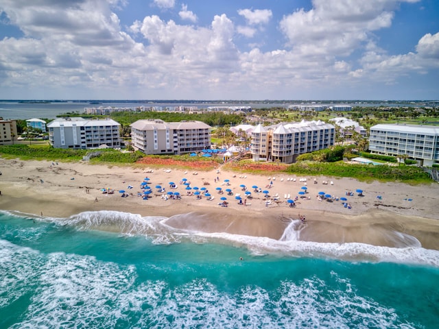 birds eye view of property with a beach view and a water view