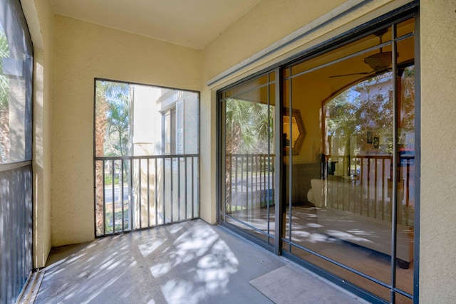 unfurnished sunroom featuring plenty of natural light and ceiling fan