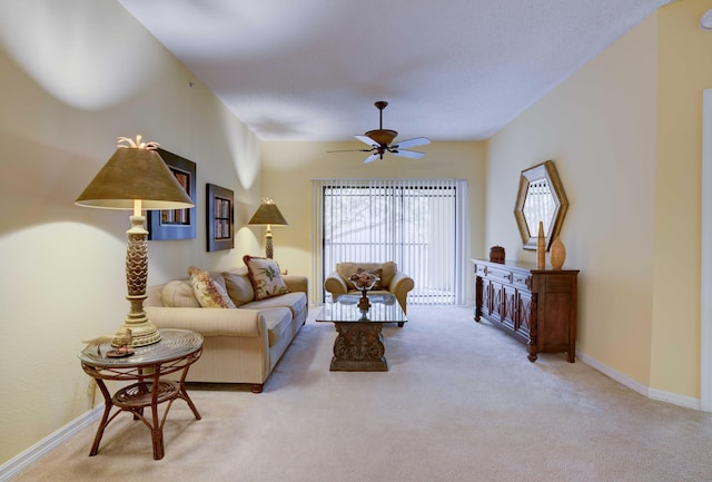 carpeted living room with ceiling fan