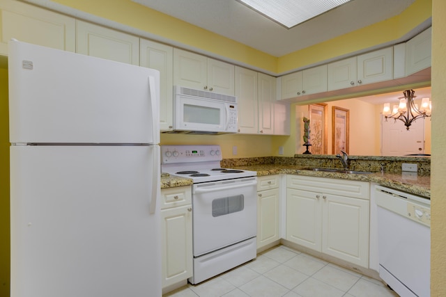 kitchen with light tile flooring, white appliances, an inviting chandelier, sink, and white cabinets