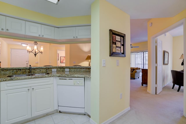 kitchen with a chandelier, light stone countertops, white cabinets, dishwasher, and sink