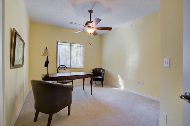 living area with light carpet, a textured ceiling, and ceiling fan