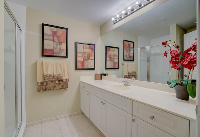 bathroom featuring large vanity, tile floors, and walk in shower