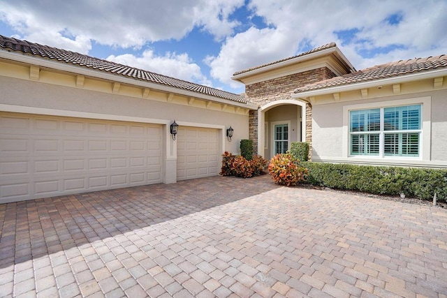 mediterranean / spanish-style house with a garage