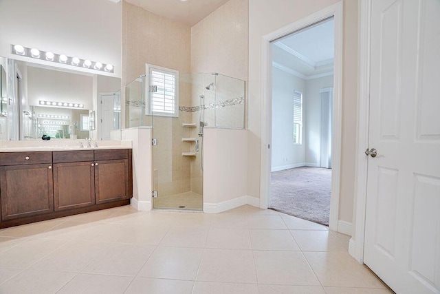 bathroom featuring vanity, ornamental molding, an enclosed shower, and tile patterned flooring