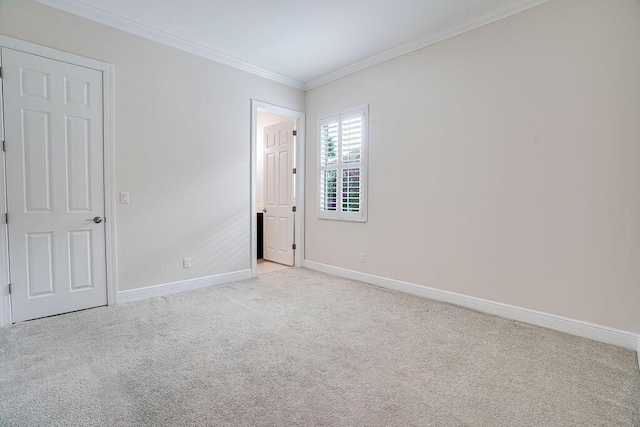 unfurnished room featuring light carpet and ornamental molding