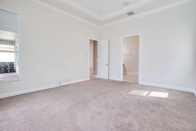 spare room with ornamental molding and carpet flooring