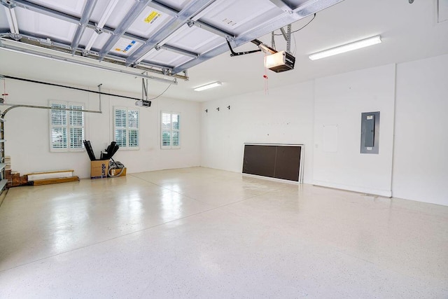 garage featuring a garage door opener and electric panel