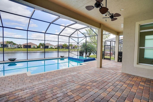 view of swimming pool with glass enclosure, a water view, an in ground hot tub, ceiling fan, and a patio