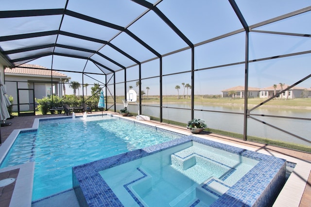 view of pool featuring a patio area, a water view, an in ground hot tub, and glass enclosure