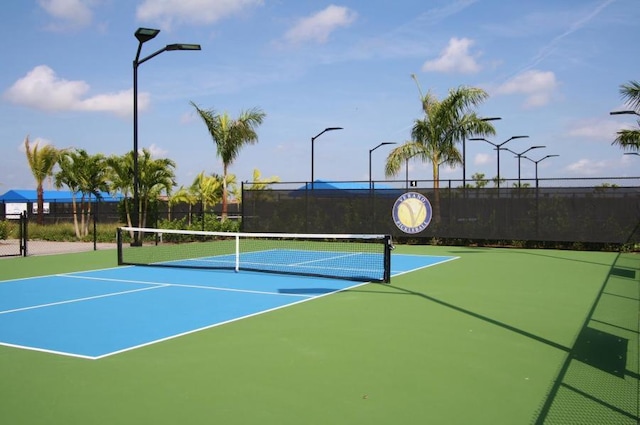 view of tennis court with basketball hoop