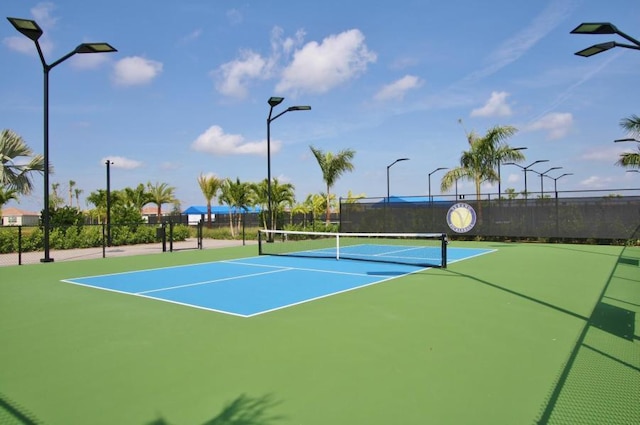 view of tennis court featuring basketball hoop