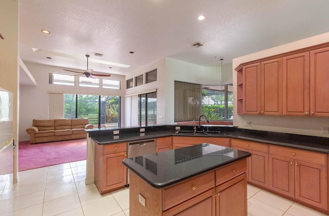 kitchen featuring a kitchen island, sink, stainless steel dishwasher, and plenty of natural light