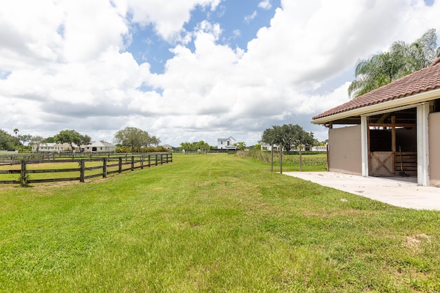 view of yard with a rural view and an outdoor structure