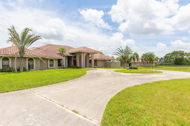 mediterranean / spanish-style house featuring a front lawn