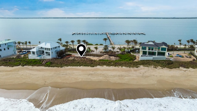 birds eye view of property featuring a water view and a view of the beach