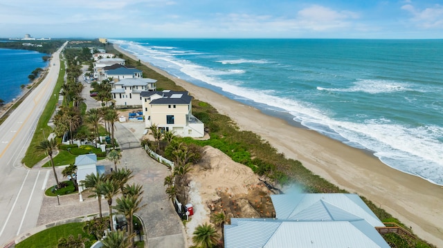 bird's eye view with a water view and a beach view