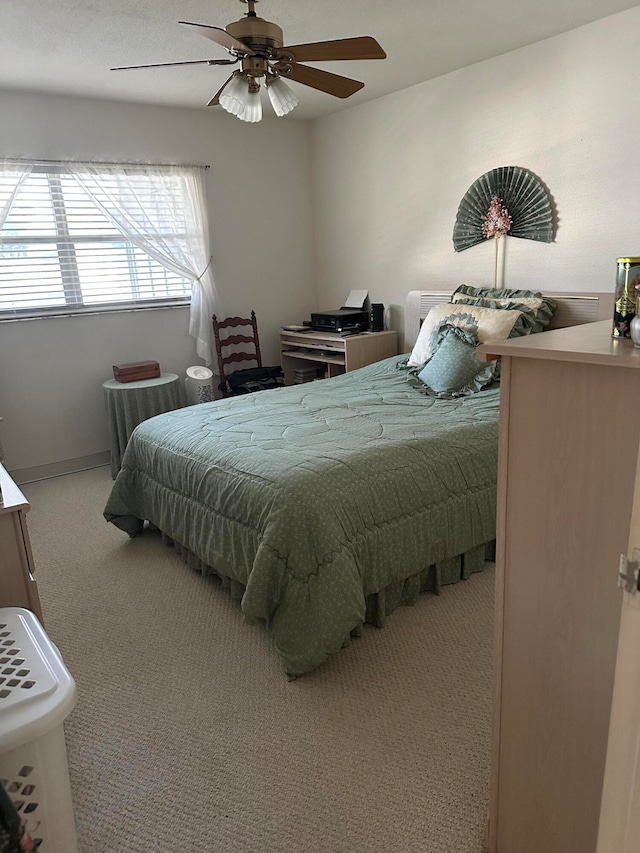 bedroom featuring light carpet and ceiling fan