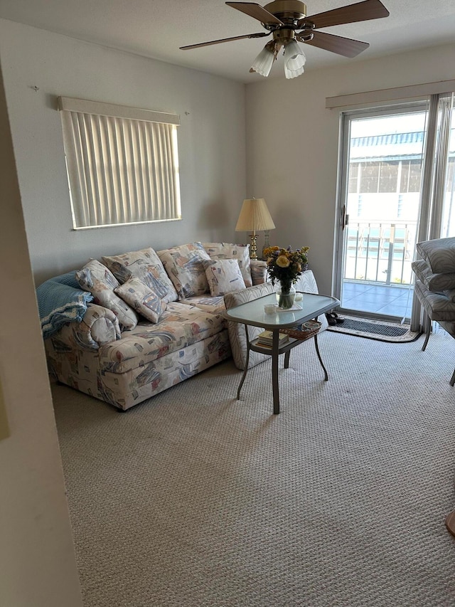 carpeted living room featuring ceiling fan