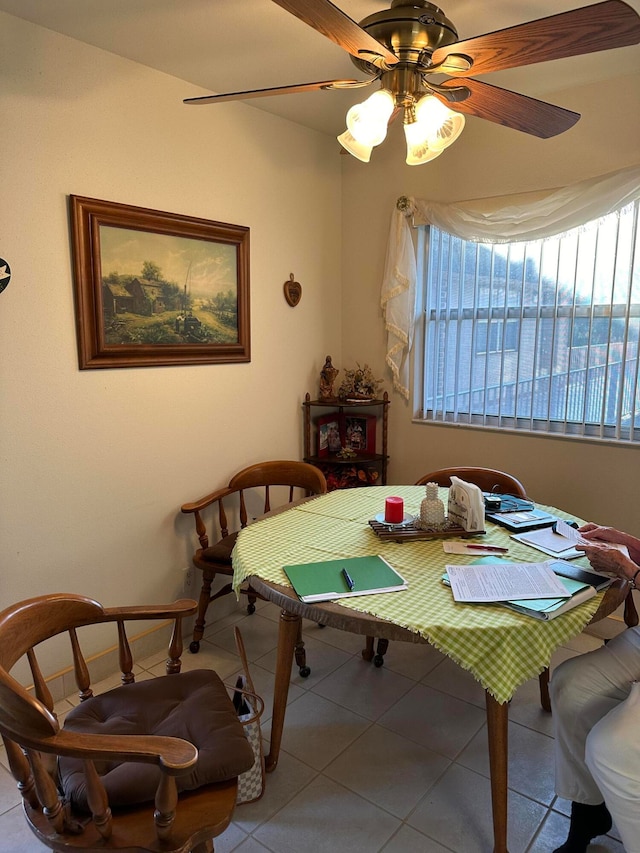 tiled dining area with ceiling fan