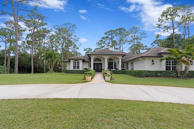 mediterranean / spanish-style house with a front yard