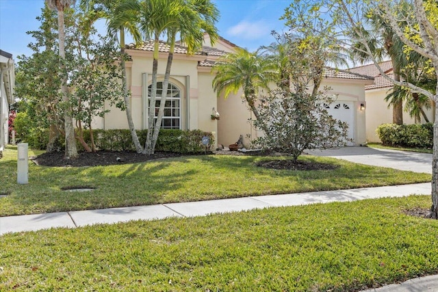 mediterranean / spanish home featuring a front lawn and a garage