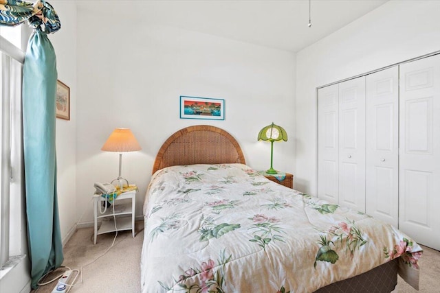 bedroom featuring a closet and light carpet