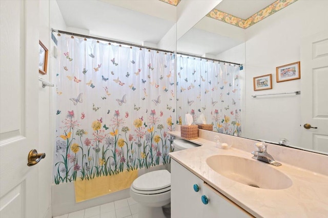 bathroom featuring toilet, vanity with extensive cabinet space, and tile floors