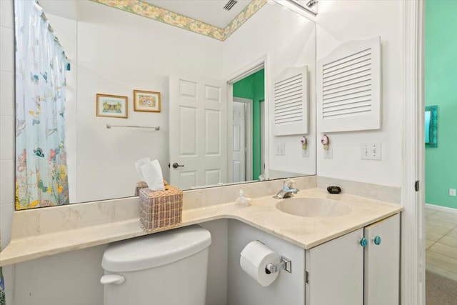 bathroom featuring toilet, tile floors, and oversized vanity