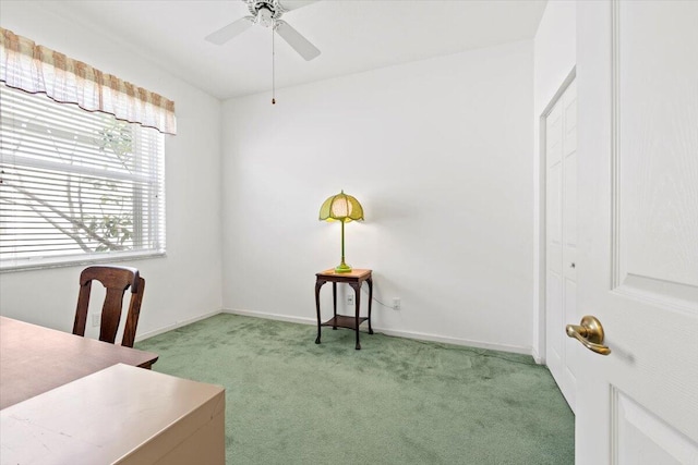 carpeted home office featuring ceiling fan