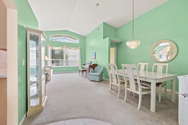 dining space featuring a notable chandelier, light carpet, and high vaulted ceiling