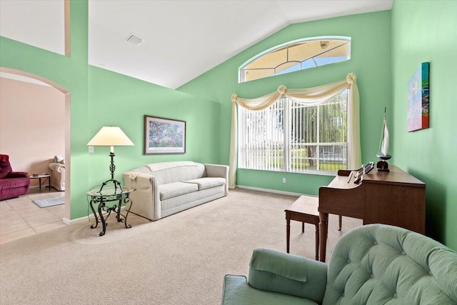 living room with light colored carpet and vaulted ceiling