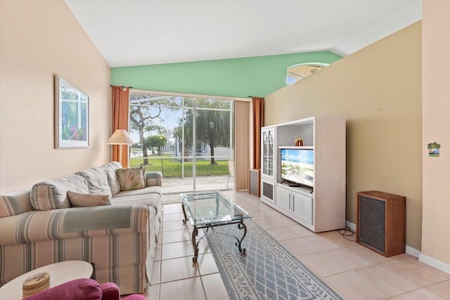 living room featuring vaulted ceiling and light tile floors