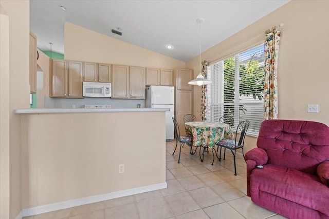 kitchen featuring light tile floors, light brown cabinetry, white appliances, lofted ceiling, and hanging light fixtures