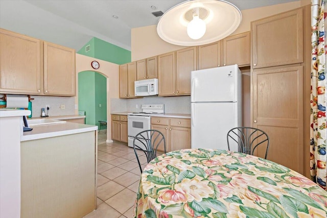 kitchen with backsplash, light tile flooring, white appliances, sink, and light brown cabinetry